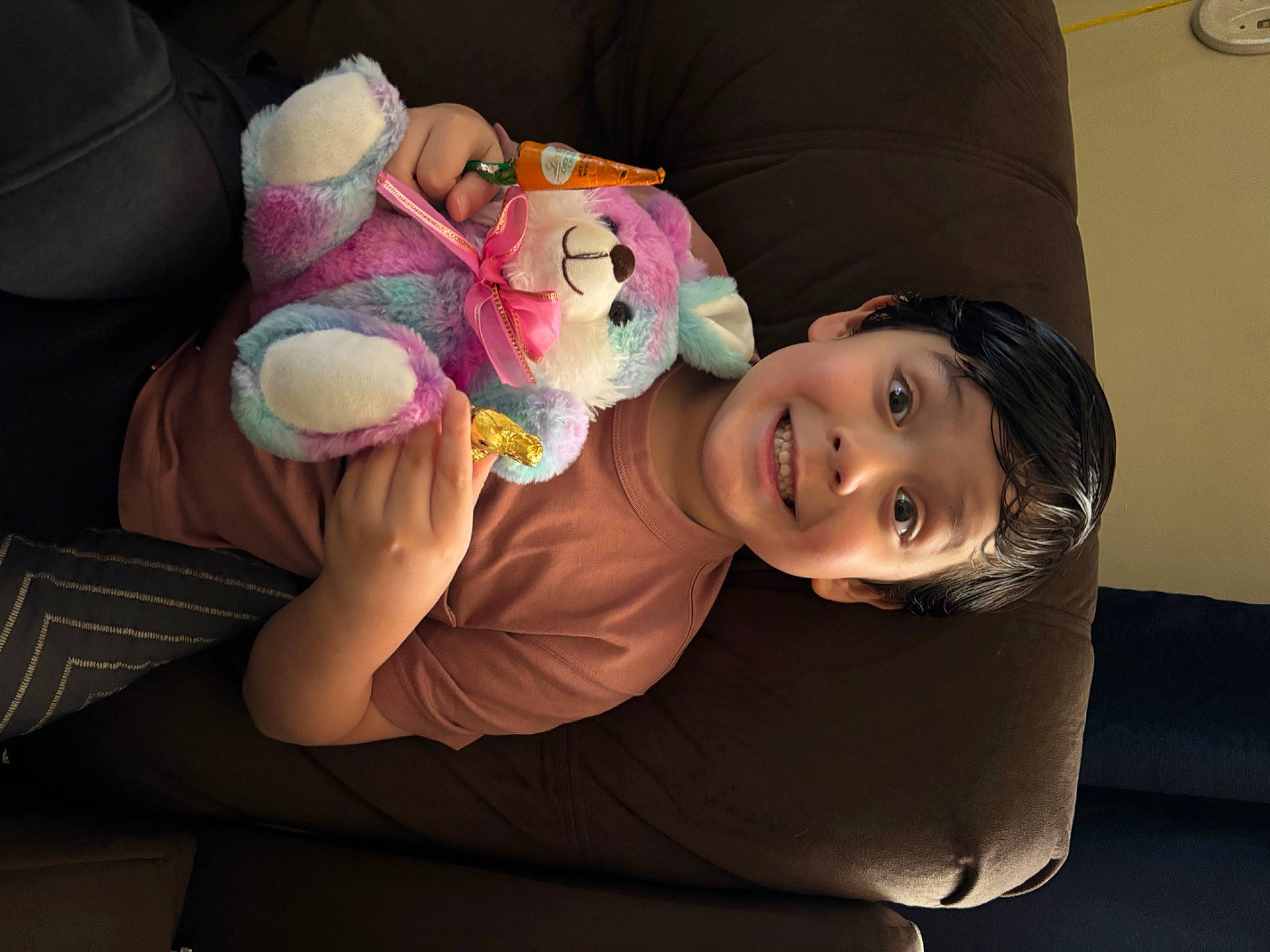 Angelo joined the competition — help win amazing prizes! arm, cheek, child, clock, comfort, flash_photography, fun, hand, happy, headwear, human_body, joy, lap, person, plush, room, sitting, skin, smile, stuffed_toy