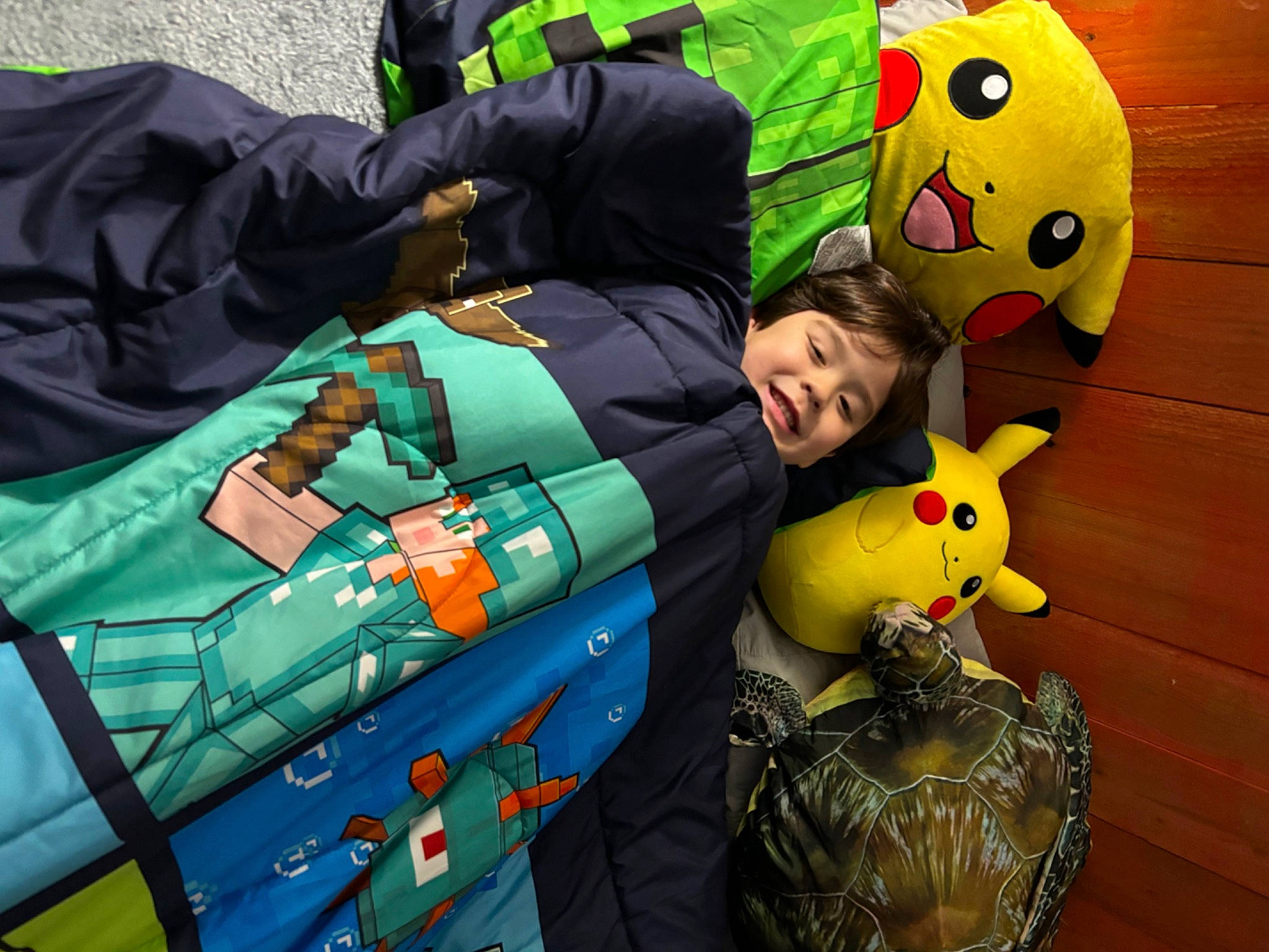 Angelo is registered to the contest to win money with this photo: baby_toys, bag, child, fictional_character, fun, green, happy, joy, leisure, luggage_and_bags, person, plastic, play, recreation, room, sitting, smile, stuffed_toy, suitcase, toddler