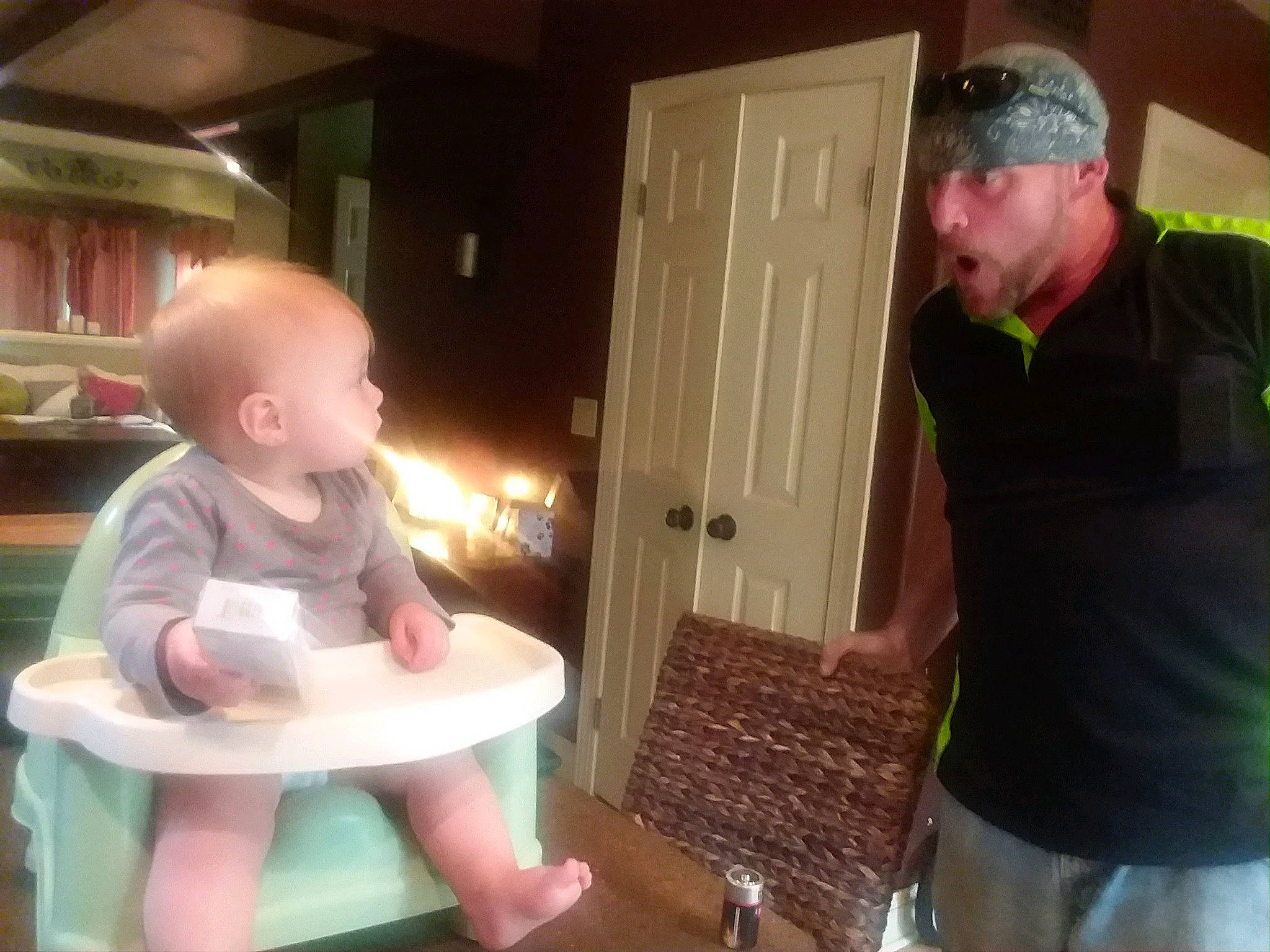 Rebecca is registered to the contest to win money with this photo: animation, baby, baby_products, baby_toddler_clothing, baseball_cap, belt, cap, child, door, event, flooring, fun, hat, headwear, lap, person, play, room, sitting, t_shirt