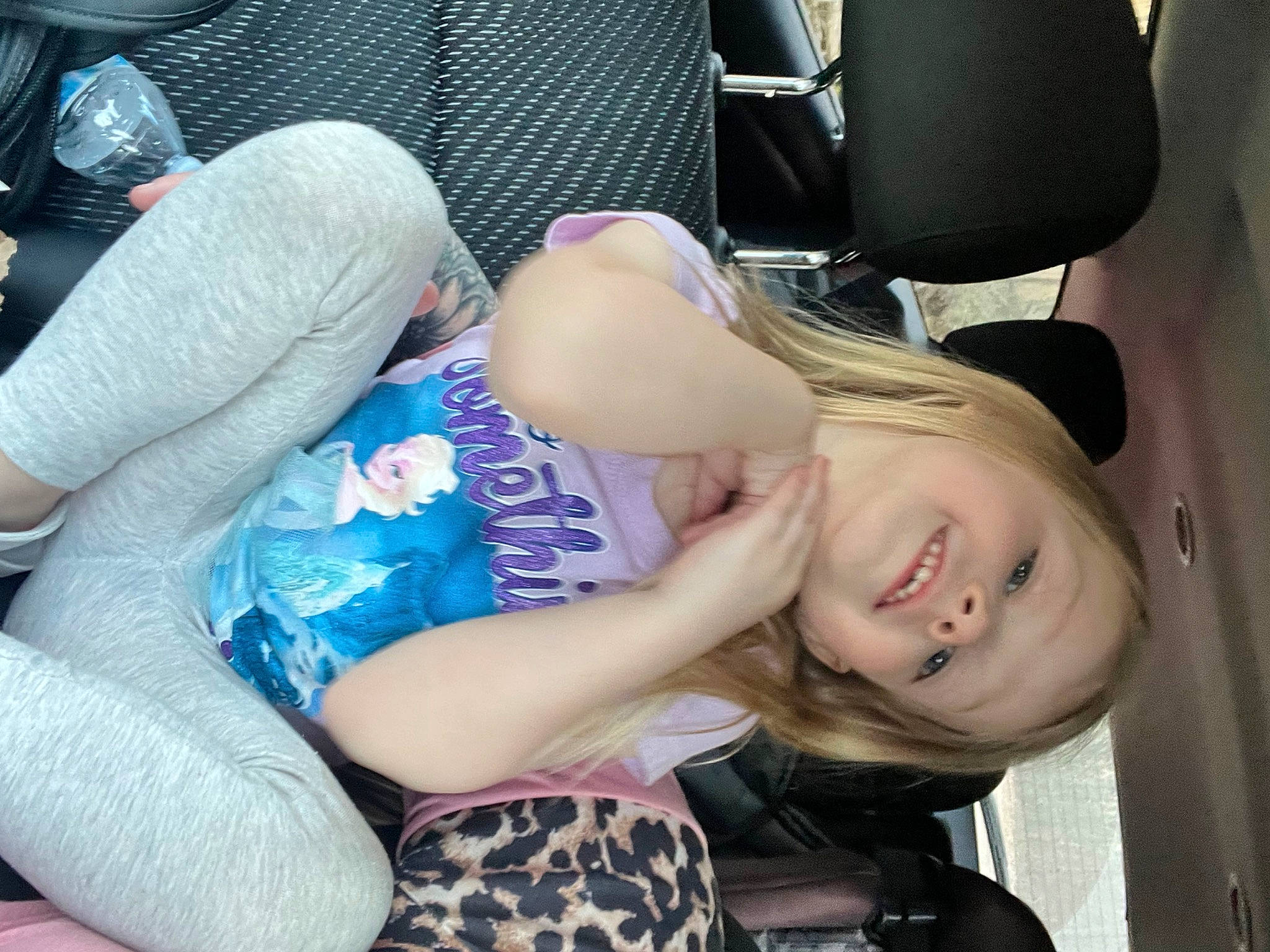 Shaylee is registered to the contest to win money with this photo: auto_part, car_seat, chest, comfort, elbow, family_car, fun, gesture, happy, head_restraint, human_leg, joint, lap, person, personal_luxury_car, sitting, smile, steering_wheel, thigh, trunk