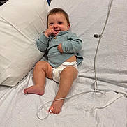 Ziloh joined the competition — help win amazing prizes! baby, smiling, hospital_bed, diaper, sweater, medical_sensor, foot, pillow, white_sheet, infant, child, cute, resting, indoors, healthcare, person, happy, young_child, lying_down, cozy