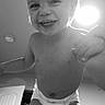 toddler, child, smiling, diaper, indoor, black_and_white, baby, happy, face, ceiling_light, hand, room, door, clothing, portrait, person, baby_skin, baby_hair, expression, ceiling
