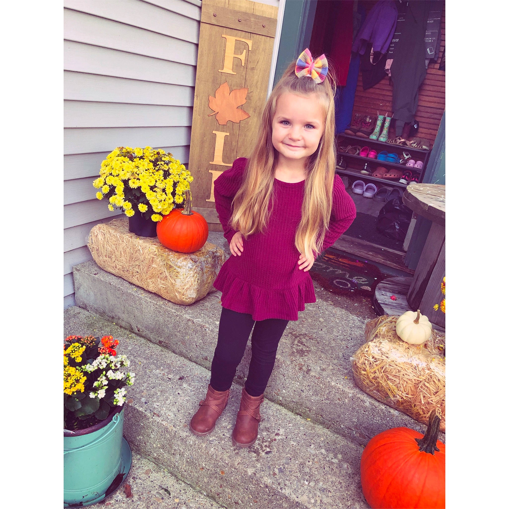 Emma is registered to the contest to win money with this photo: calabaza, child, door, flooring, flower, flowerpot, happy, houseplant, joy, magenta, orange, person, photograph, plant, pumpkin, purple, sleeve, sportswear, street_fashion, t_shirt
