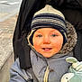 Elyo a rejoint le concours — aidez-le/la à gagner de superbes lots ! toddler, child, baby, winter_clothing, knit_hat, blue_eyes, stroller, stuffed_toy, outdoor, urban, smile, jacket, cozy, cold_weather, face, portrait, cute, closeup, baby_toy, happy