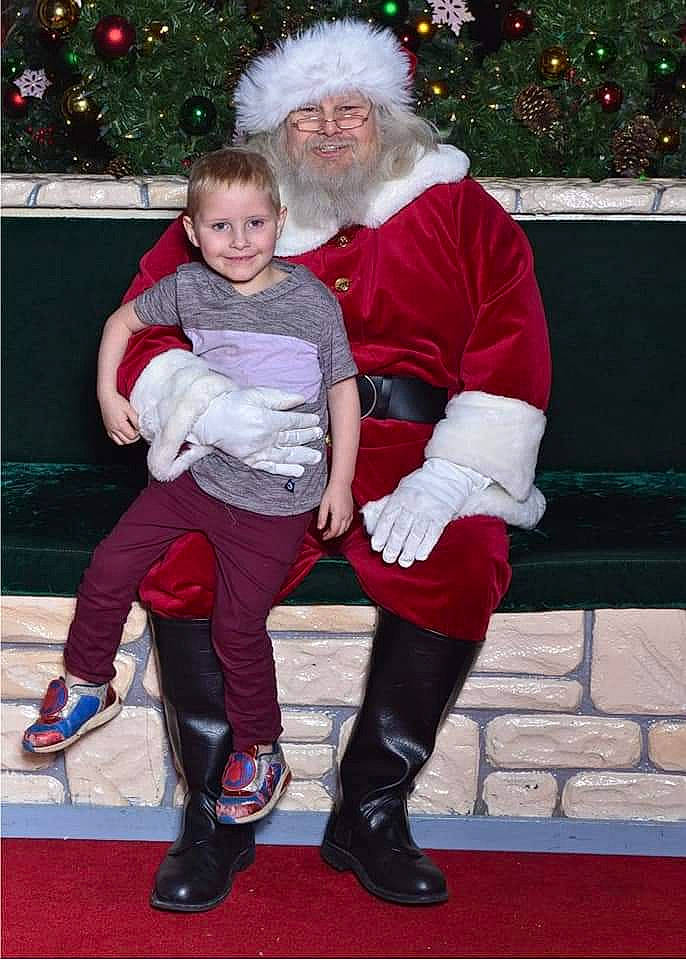 Dalton joined the competition — help win amazing prizes! black, christmas_tree, footwear, fun, green, hair, happy, head, headwear, human_body, joy, lap, organ, people, person, photograph, red, santa_claus, smile, standing