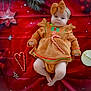 baby, infant, child, gingerbread_outfit, headband, bow, candy_cane, red_blanket, holiday_theme, christmas, festive, decorations, ornaments, cute, lying_down, soft_texture, chubby_legs, portrait, indoor, celebration