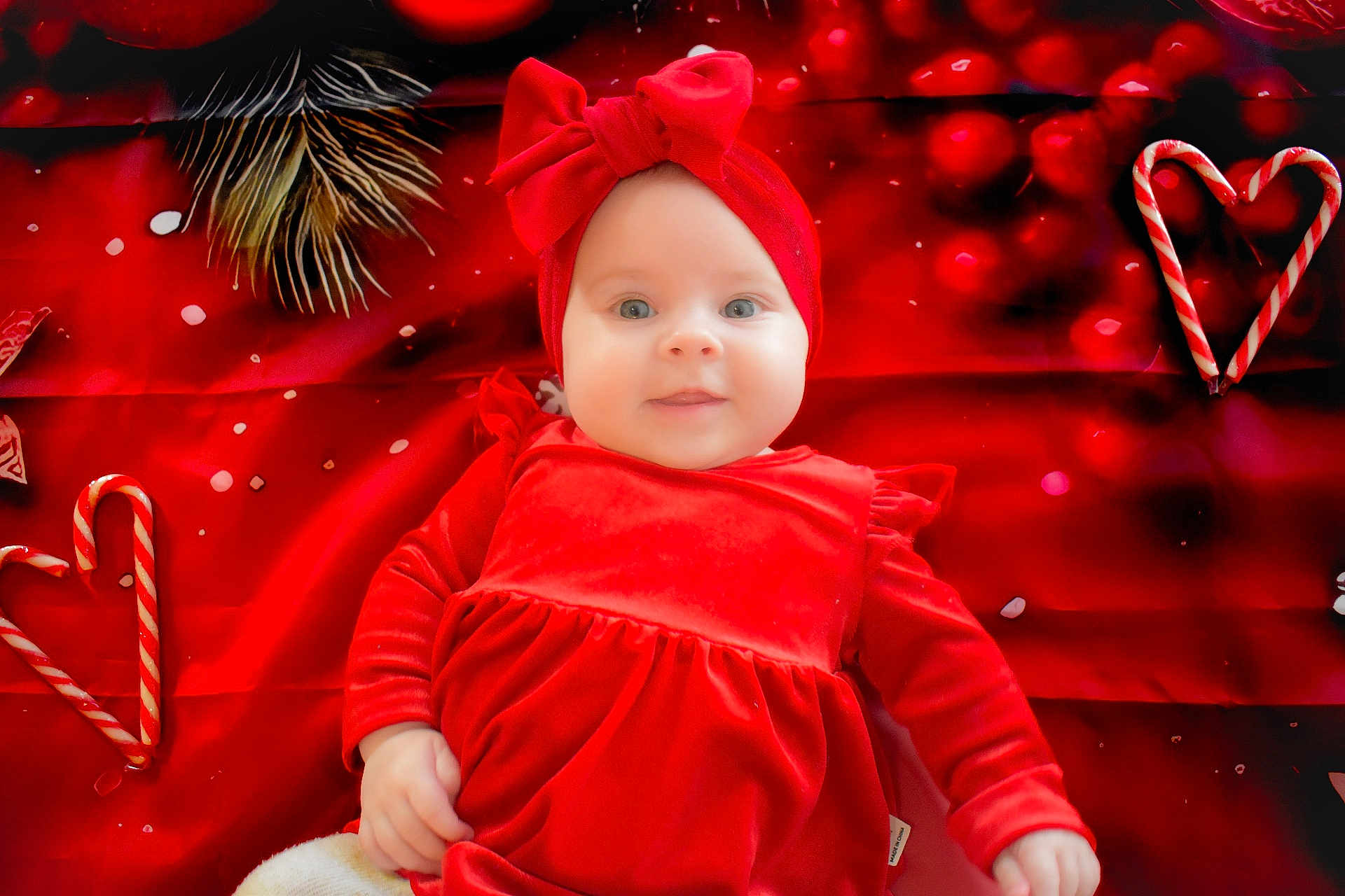 Joy participe au concours pour gagner de l'argent avec cette photo : baby, child, red_dress, headband, bow, candy_canes, heart_shape, festive, holiday, cute, infant, smiling, portrait, soft_fabric, closeup, lying_down, celebration, christmas_theme, happy, background