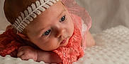 Joy a rejoint le concours — aidez-le/la à gagner de superbes lots ! baby, blanket, blue_eyes, child, closeup, coral_clothing, curious, cute, face, hand, headband, indoors, infant, lace, newborn, portrait, resting, skin, soft_light, texture