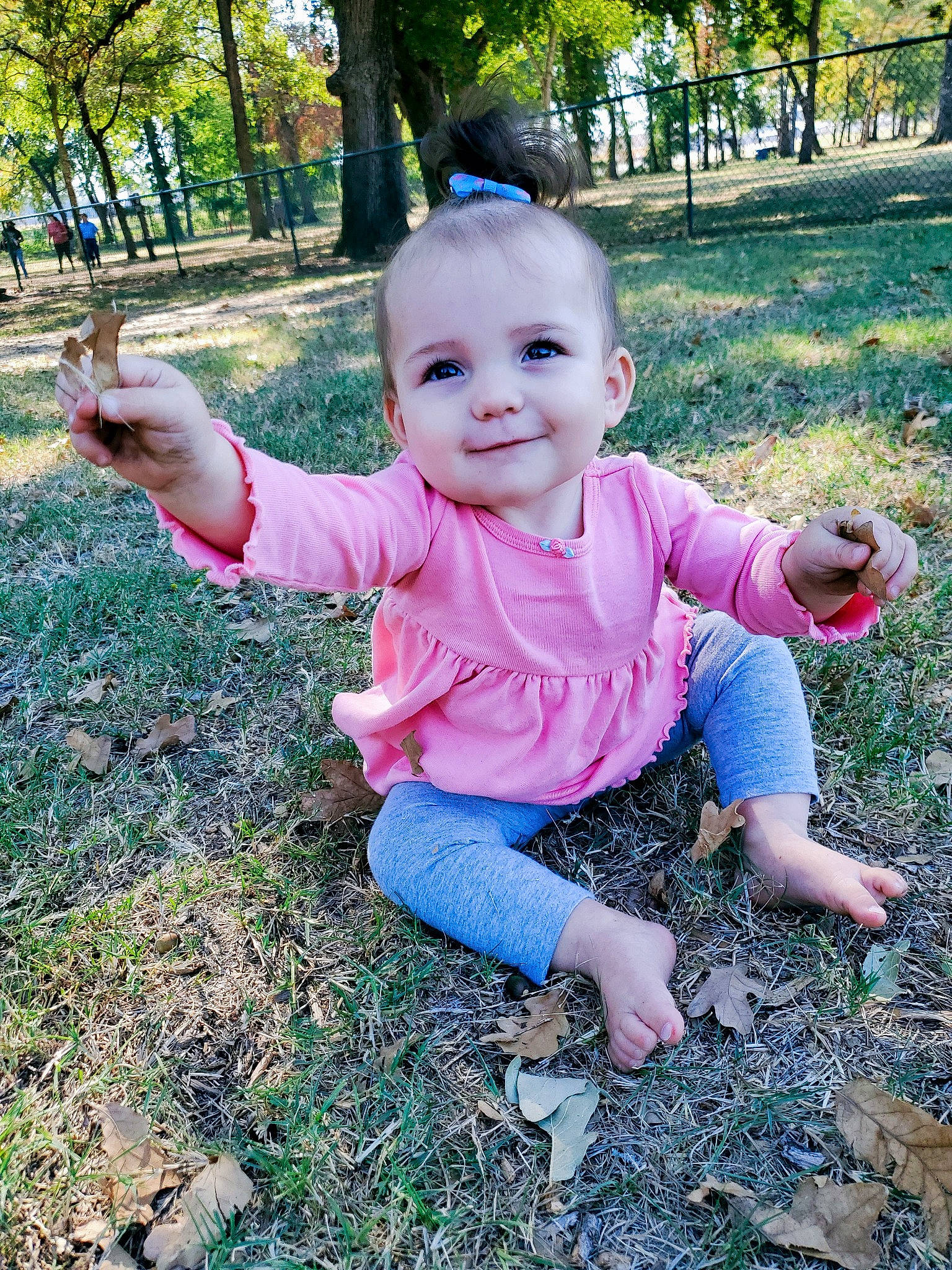 Wisteria is registered to the contest to win money with this photo: baby, baby_toddler_clothing, child, finger, fun, garden, grass, grass_family, groundcover, happy, joy, lawn, people_in_nature, person, pink, plant, recreation, sitting, smile, thumb