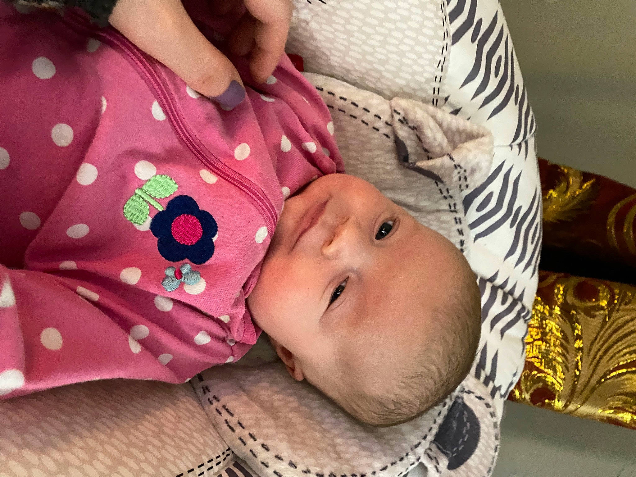 Gwen is registered to the contest to win money with this photo: baby, baby_products, baby_sleeping, baby_toddler_clothing, cheek, child, collar, comfort, eye, eyelash, fashion_accessory, happy, linens, lip, pattern, peach, person, skin, sleeve, textile