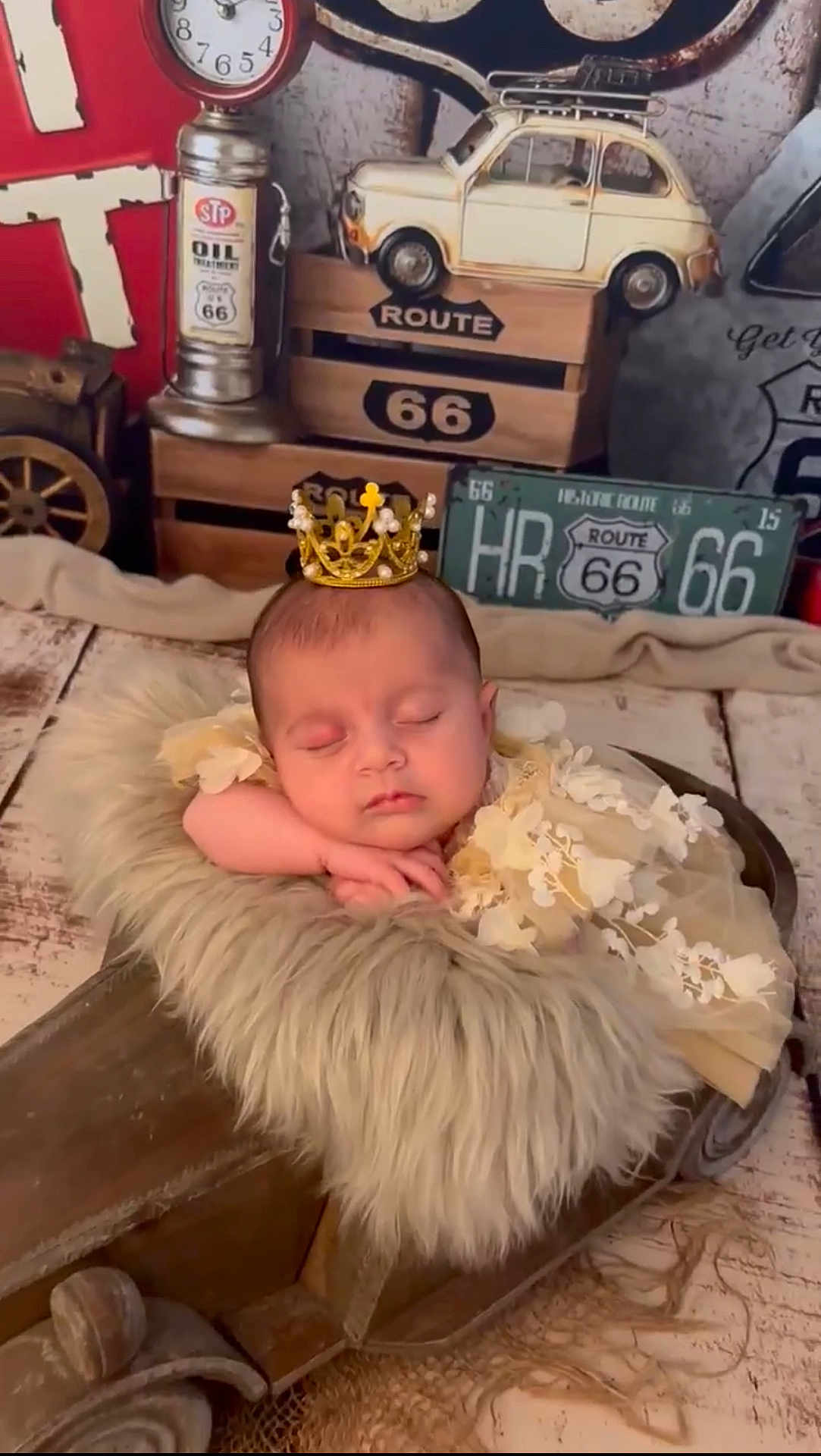 Rose a rejoint le concours — aidez-le/la à gagner de superbes lots ! baby, sleeping, crown, floral_dress, fur_blanket, wooden_prop, vintage_decor, route_66, toy_car, rustic, cozy, peaceful, infant, portrait, indoor, decorative, cute, resting, soft_texture, child