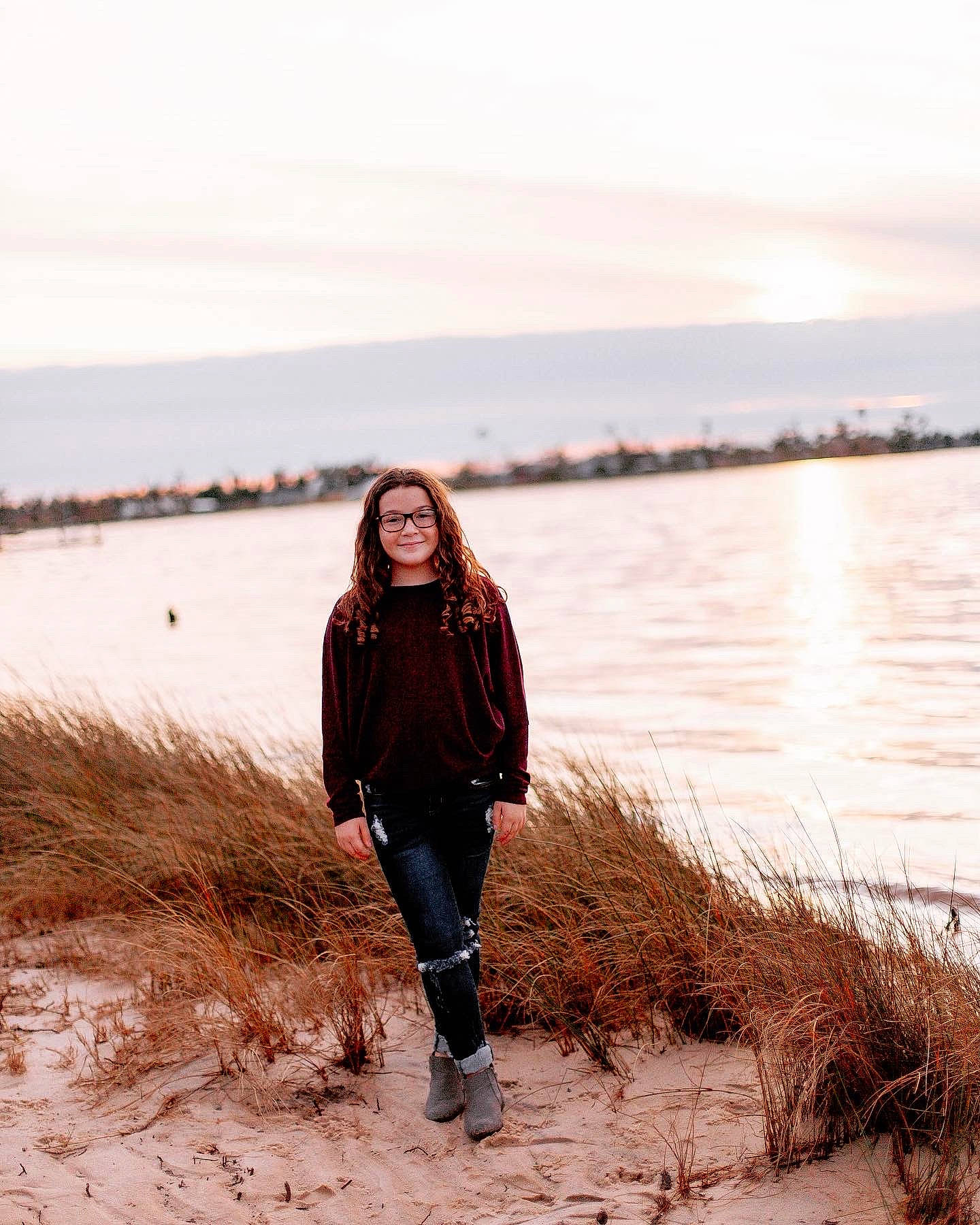 Bryanna is registered to the contest to win money with this photo: bank, body_of_water, branch, flash_photography, grass, happy, horizon, joy, lake, landscape, natural_landscape, outerwear, people_in_nature, person, plant, sky, standing, street_fashion, sunlight, tree
