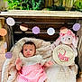 3_month, baby, blanket, celebration, circle_garland, cute, decorations, garden, infant, natural_light, outdoor, pink_skirt, plush_toy, portrait, sitting, soft_texture, toy_bunny, white_top, wooden_crate, young_child