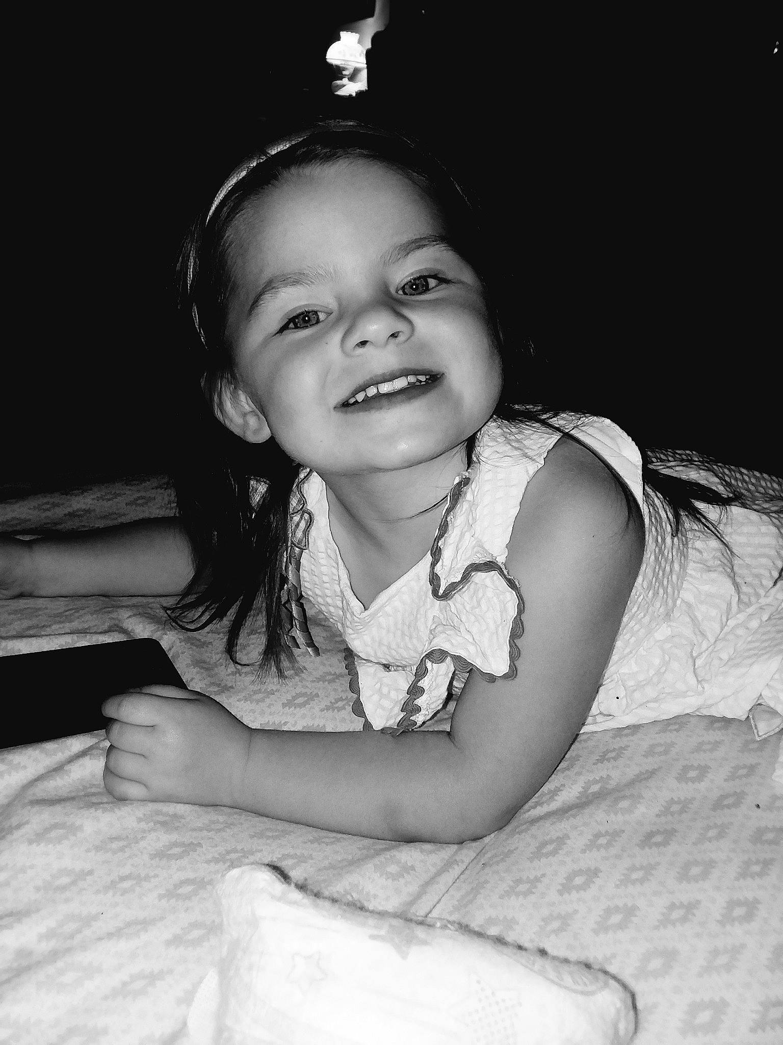 Taelyn is registered to the contest to win money with this photo: beauty, black, black_and_white, cheek, child, emotion, eye, face, facial_expression, girl, head, joy, monochrome_photography, nose, person, photograph, photography, sitting, skin, smile