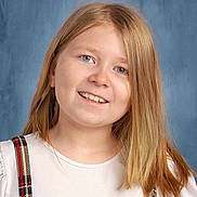 Adaline joined the competition — help win amazing prizes! child, girl, smiling, portrait, blonde_hair, white_shirt, plaid_suspender, blue_background, face, happy, person, casual_clothing, youth, head_and_shoulders, studio_photo, light_skin, long_hair, friendly_expression, school_photo, indoors