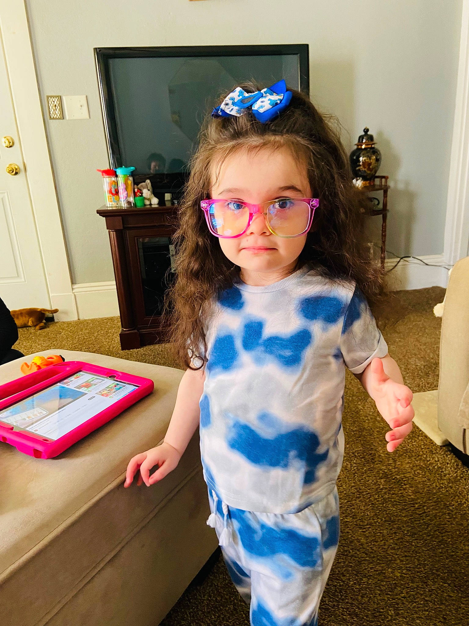 Alexandria is registered to the contest to win money with this photo: baby_toddler_clothing, blue, child, drawer, electric_blue, event, eyewear, face, flooring, fun, glasses, party, person, picture_frame, play, room, standing, table, television, toddler