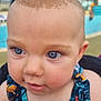 baby, child, blue_eyes, close_up, curious, face, infant, outdoor, pool, swimwear, tropical_pattern, portrait, skin, head, person, young, summer, vacation, water, daylight