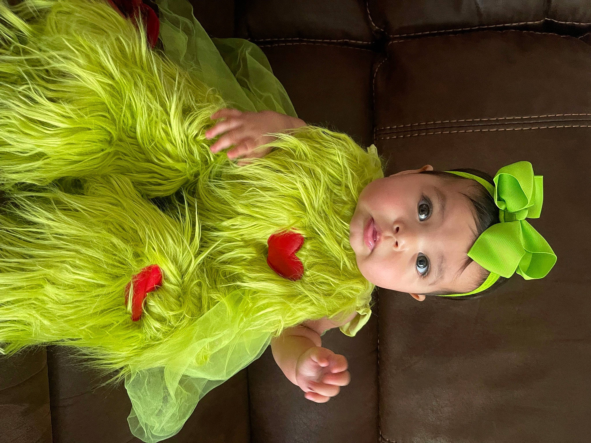 Vivienne is registered to the contest to win money with this photo: baby, baby_toddler_clothing, child, costume, cut_flowers, event, fashion_design, feather, fun, fur, grass, happy, hat, magenta, natural_material, person, plant, terrestrial_plant, toddler