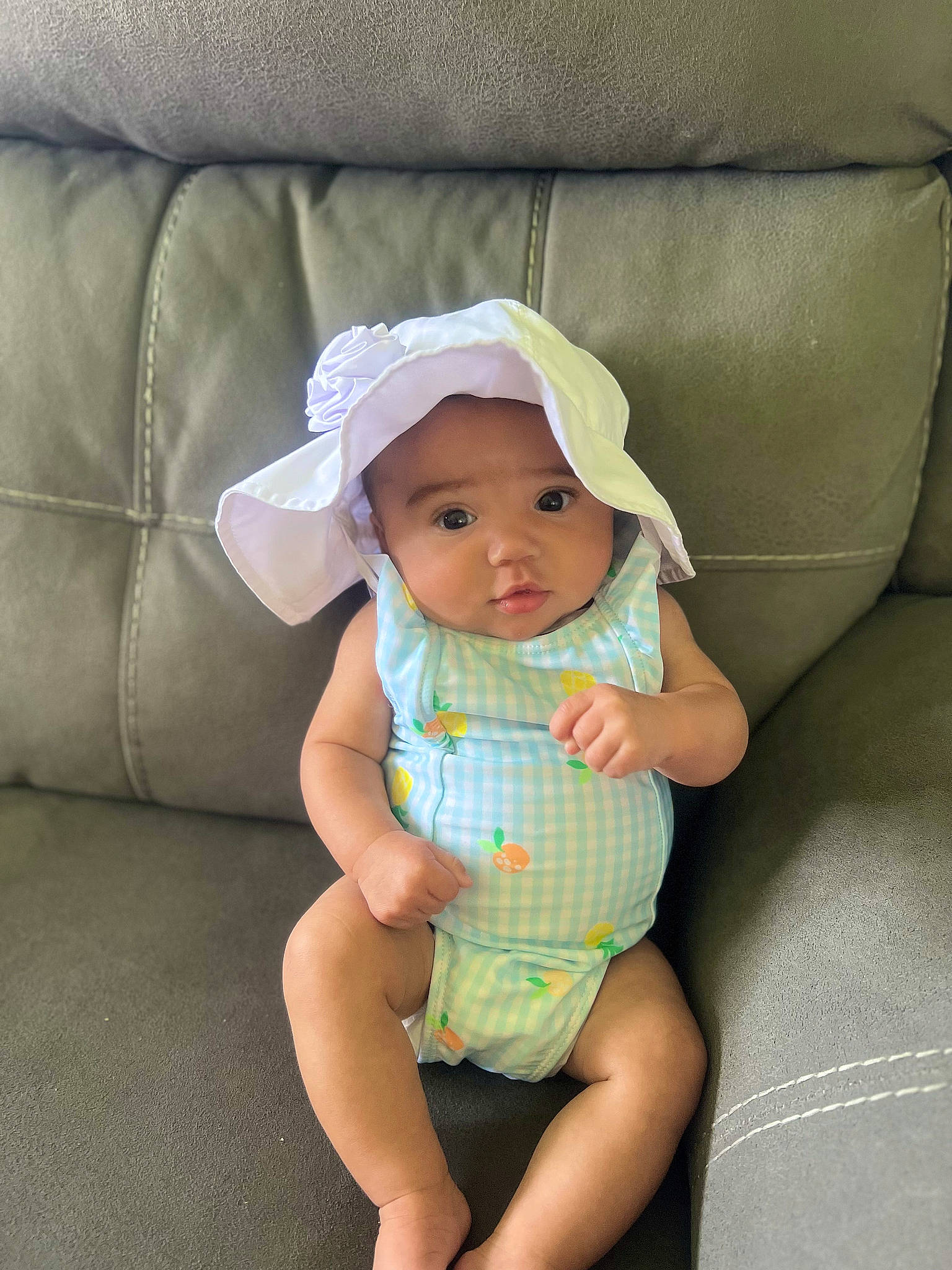 Clarissa joined the competition — help win amazing prizes! baby, baby_products, baby_toddler_clothing, cap, child, comfort, couch, fashion_accessory, foot, hat, headwear, human_leg, knee, linens, pattern, person, sitting, skin, sleeve, sun_hat
