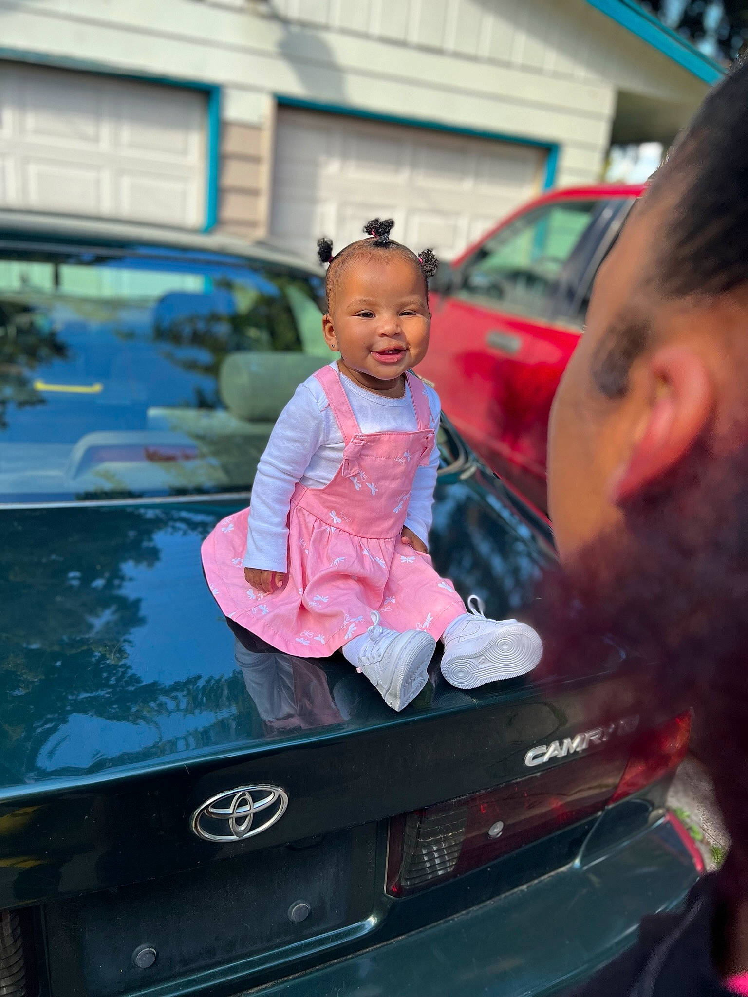 Elani is registered to the contest to win money with this photo: auto_part, automotive_design, automotive_exterior, automotive_lighting, automotive_tail_brake_light, automotive_window_part, bumper, car, child, family_car, luxury_vehicle, magenta, mode_of_transport, motor_vehicle, person, personal_luxury_car, toddler, trunk, vehicle, vehicle_door