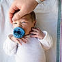 Wyatt joined the competition — help win amazing prizes! newborn, baby, pacifier, hand, white_onesie, blanket, infant, lying_down, adult_hand, closeup, skin, face, sleepy, small_fingers, cozy, comfort, care, protection, indoor, tender_moment