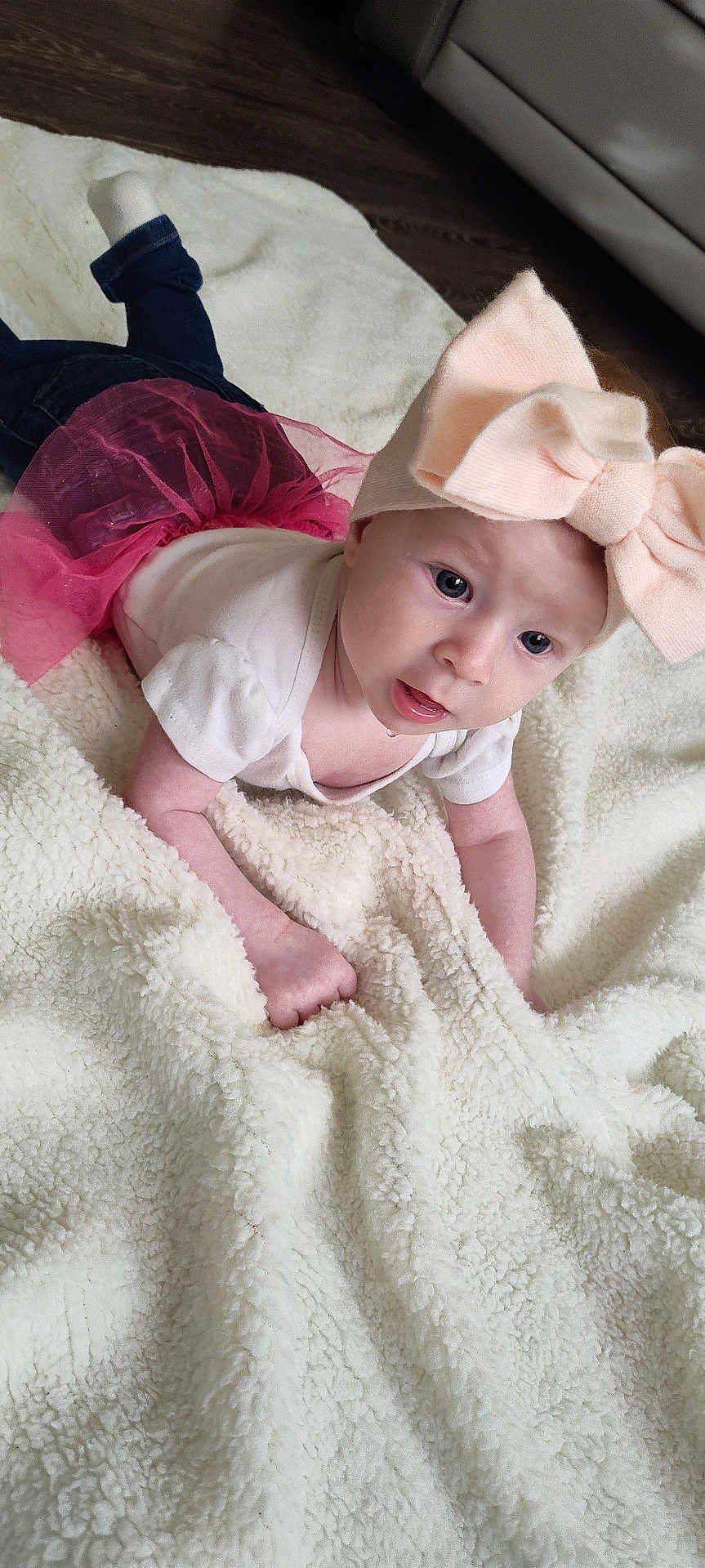Aurora is registered to the contest to win money with this photo: baby, child, pink_bow, headband, white_shirt, pink_tutu, blanket, fluffy, drool, curious, indoor, floor, wood_floor, crawling, cute, young, infant, baby_clothes, soft_texture, portrait