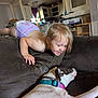 Joaleen joined the competition — help win amazing prizes! toddler, dog, couch, living_room, child, pet, smiling, relaxed, indoor, playful, happy, animal, furniture, casual, home, blond_hair, collar, diaper, interaction, person