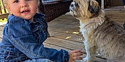 Joaleen joined the competition — help win amazing prizes! toddler, child, dog, denim_jacket, jeans, sneakers, porch, wooden_floor, wicker_chair, door, outdoor, pet, cute, smiling, daylight, animal, person, casual_clothing, small_dog, playful