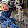 toddler, child, dog, denim_jacket, jeans, sneakers, porch, wooden_floor, wicker_chair, door, outdoor, pet, cute, smiling, daylight, animal, person, casual_clothing, small_dog, playful