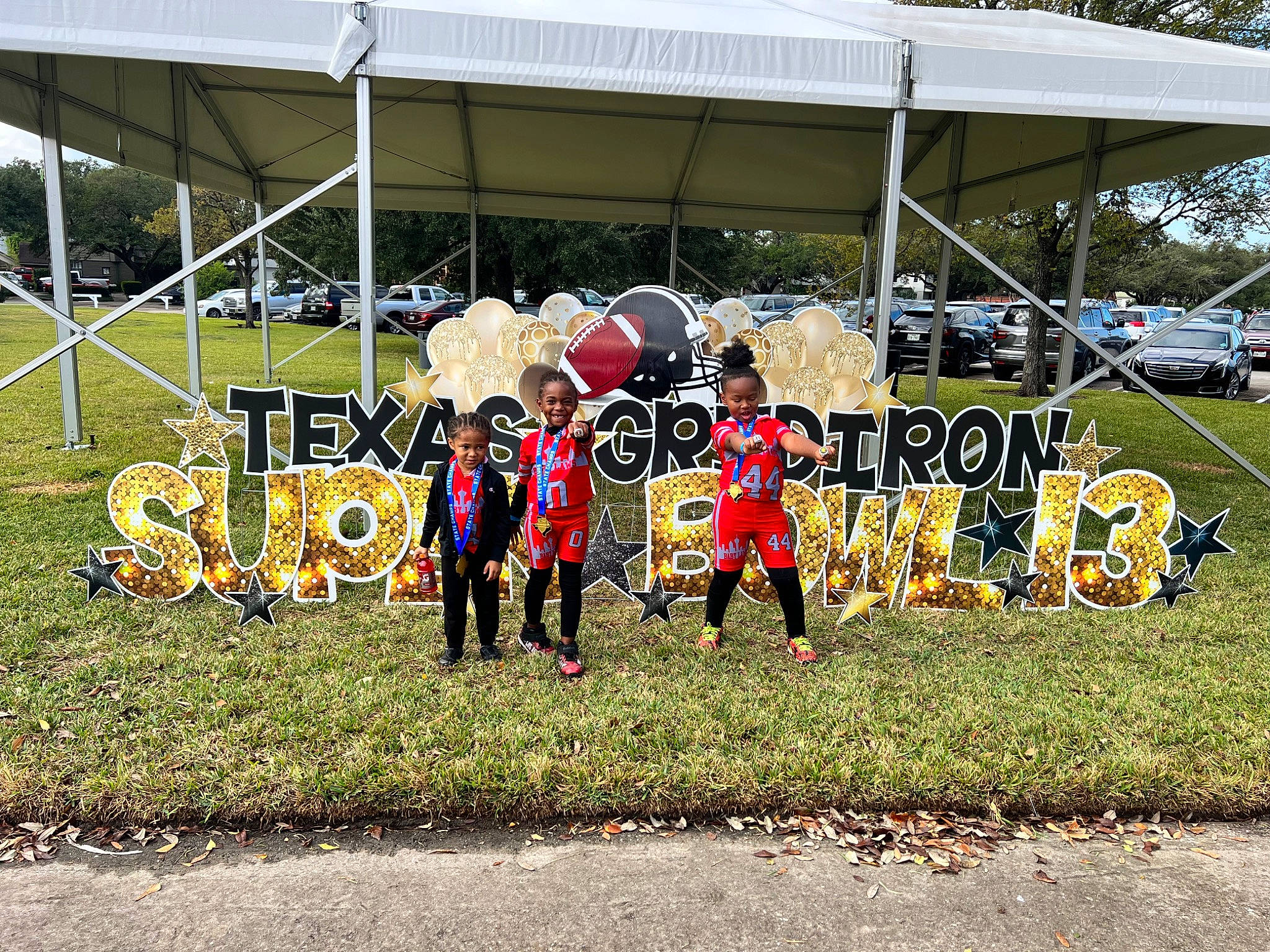 Kendrick is registered to the contest to win money with this photo: art, asphalt, auto_part, automotive_tire, automotive_wheel_system, chair, city, competition_event, event, grass, hat, joy, leisure, motor_vehicle, person, plant, public_event, recreation, shade, tire