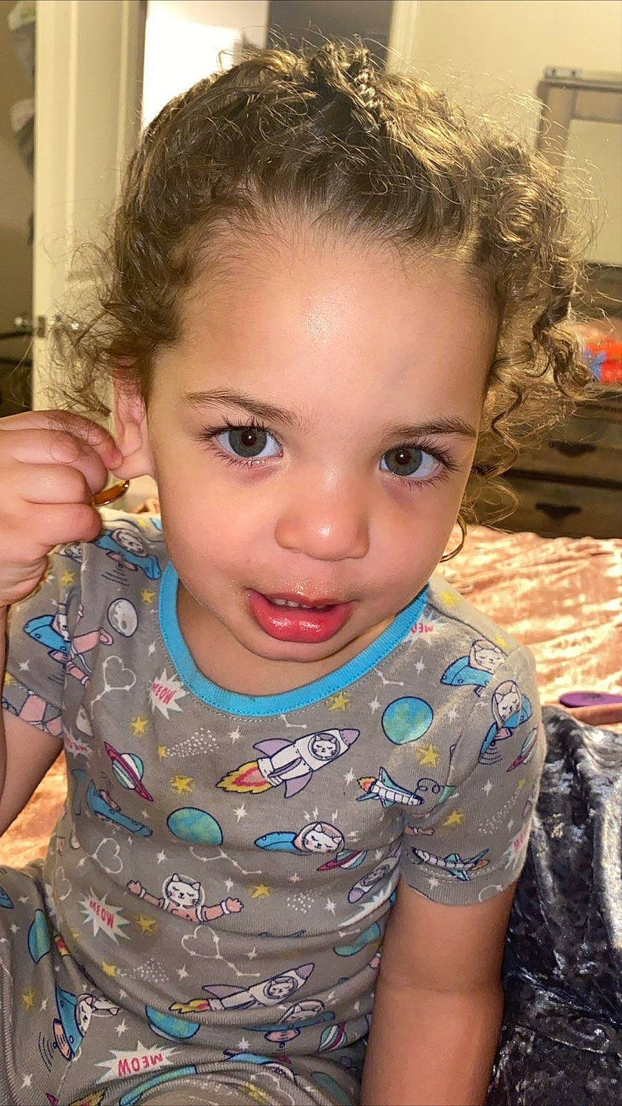 Penny is registered to the contest to win money with this photo: black_hair, brown_hair, cheek, child, child_model, chin, eyebrow, face, forehead, hair, hairstyle, head, iris, lip, long_hair, nose, person, skin, smile, toddler