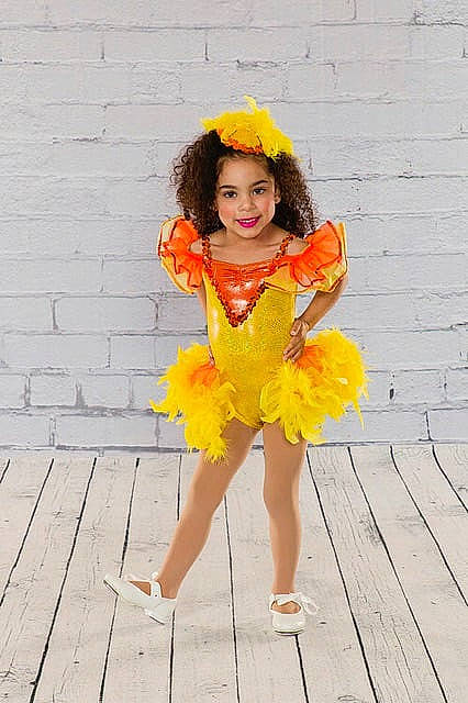 Taleigha is registered to the contest to win money with this photo: child, child_model, clothing, costume, dress, fashion_accessory, flower, fun, joy, orange, person, plant, ruffle, smile, toddler, yellow