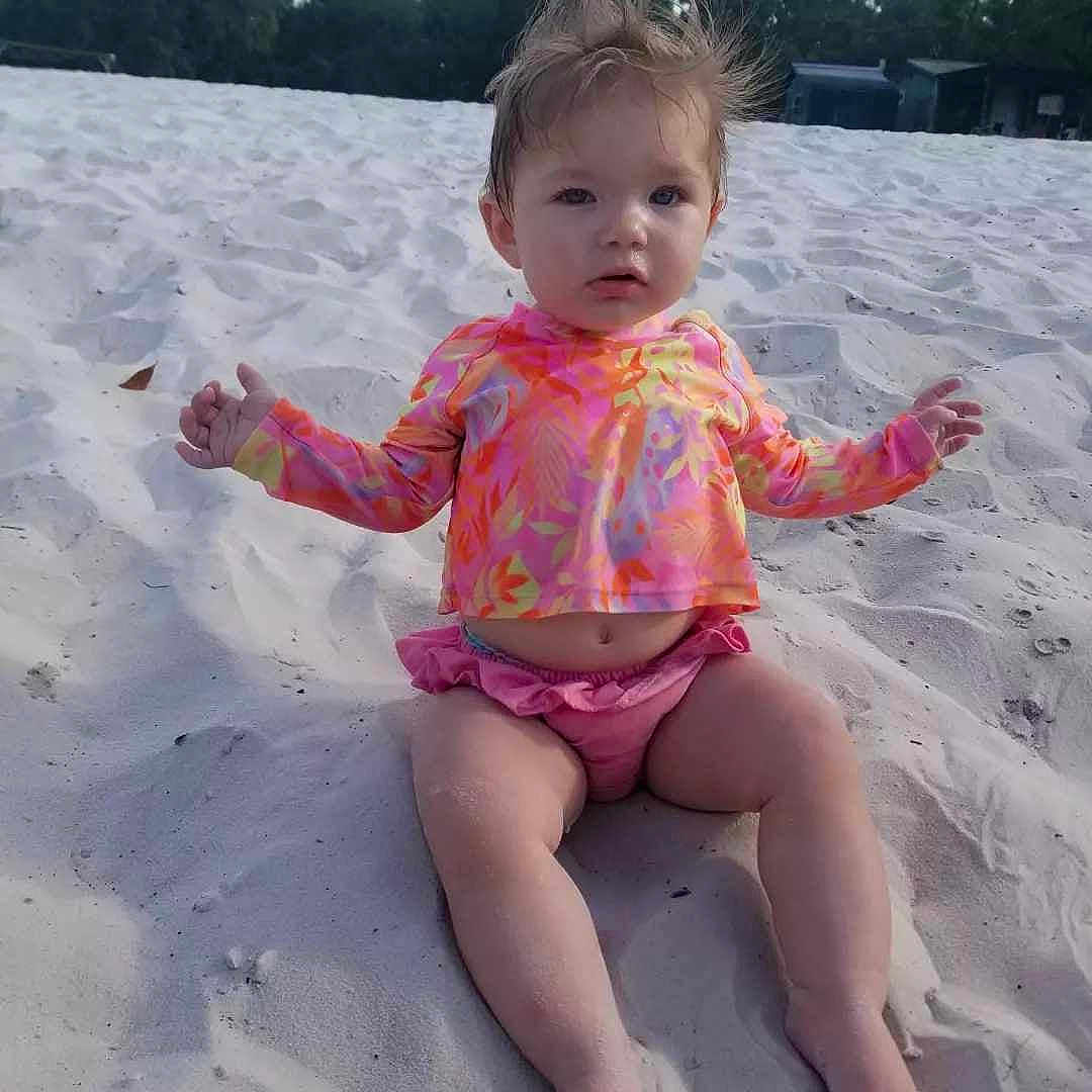 Harley joined the competition — help win amazing prizes! baby, beach, clothing, coast, diaper, face, head, nature, outdoors, person, photography, portrait, sand, sea, shoreline, shorts, sitting, summer, swimwear, water