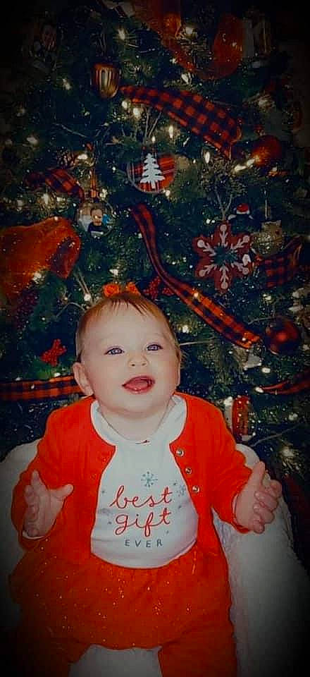 Raelynn joined the competition — help win amazing prizes! baby, baby_toddler_clothing, bib, cheek, child, christmas, christmas_decoration, christmas_eve, christmas_lights, christmas_ornament, christmas_tree, conifer, holiday, holiday_ornament, interior_design, lip, organ, ornament, person, pleased