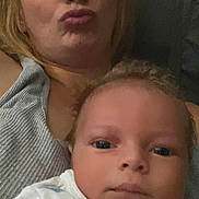 Josiah joined the competition — help win amazing prizes! baby, infant, adult, mother, portrait, selfie, indoors, couch, seated, face, eyes, blonde_hair, duck_face, onesie, baby_clothing, close_up, family, home, photograph, calm