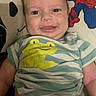 baby, infant, child, smiling, portrait, indoors, bed, pillow, spiderman, superhero, frog_shirt, striped_clothing, diaper, seated, happy, face, blond_hair, blue_eyes, cozy, photography