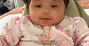 Daniela is registered to the contest to win money with this photo: baby, child, infant, pink, floral, headband, bow, necklace, cute, smiling, indoors, person, portrait, clothing, hand, furniture, home, soft, closeup, young
