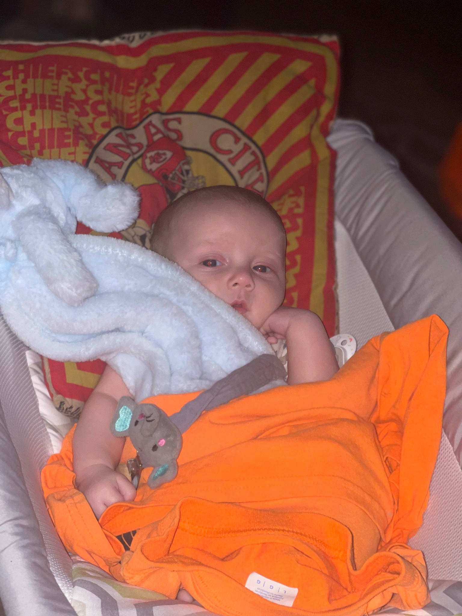 Odin is registered to the contest to win money with this photo: baby, baby_products, baby_toddler_clothing, bedtime, cheek, child, comfort, eye, face, finger, head, human_body, iris, lap, mouth, orange, person, product, sitting, skin