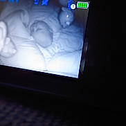 Jasper is registered to the contest to win money with this photo: baby, monitor, night_vision, sleeping, blanket, infant, nursery, technology, screen, dark, soft_lighting, indoor, child, bed, cozy, quiet, rest, home, security, camera