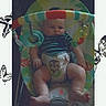 Jasper joined the competition — help win amazing prizes! baby, infant, baby_rocker, toy_bar, striped_clothing, diaper, carpet, butterfly_border, colorful, indoor, child, cute, seat, legs, arms, face, expression, playtime, relaxed, home