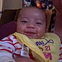 Cherish is registered to the contest to win money with this photo: baby, smile, adult, hand, yellow_bib, striped_clothing, indoor, poster, anime, colorful, person, closeup, face, joyful, child, holding, couch, background, happy, portrait