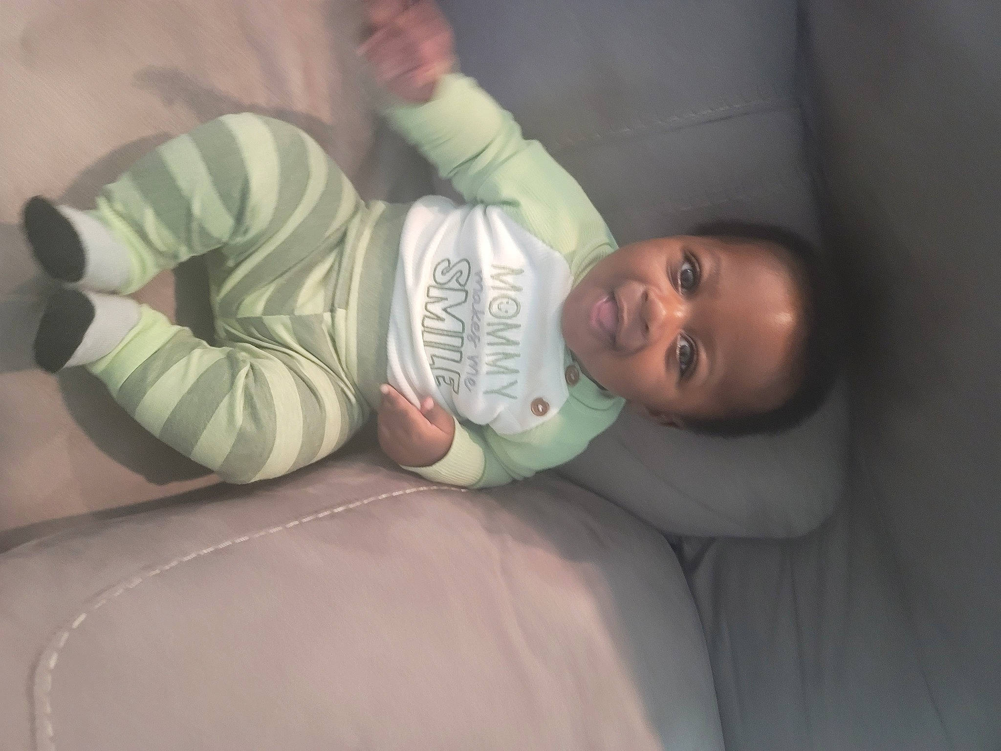 Maxwell is registered to the contest to win money with this photo: baby, baby_products, baby_toddler_clothing, cheek, child, comfort, elbow, flash_photography, happy, hat, human_body, joy, knee, linens, mouth, person, room, sitting, sleep, sleeve