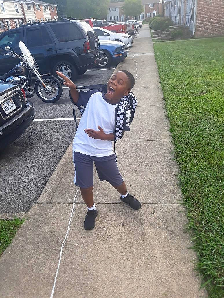 Jai is registered to the contest to win money with this photo: car, child, person, recreation, road, sidewalk, tree, vacation, vehicle, walking