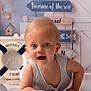 Camille a rejoint le concours — aidez-le/la à gagner de superbes lots ! baby, child, crawling, striped_clothing, blue, nautical, life_preserver, ocean_theme, indoor, floor, smiling, blond_hair, decor, signs, background, happy, portrait, cute, infant, playful