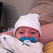 Malakai joined the competition — help win amazing prizes! baby, infant, pacifier, hat, blanket, swaddle, face, person, indoors, quilt, comfort, child, cute, soft, clothing, newborn, resting, closeup, sleepy, portrait