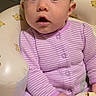 baby, baby_seat, child, comfortable, cozy, curious_expression, cute, face, head, indoor, infant, portrait, purple_pajamas, seated, small_hands, soft_lighting, striped_clothing, teddy_bear_pattern, wide_eyes, young_child