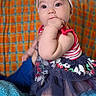 Annaliese joined the competition — help win amazing prizes! baby, background, blanket, bow, child, clothing, colorful, curious, cute, dress, fabric, furniture, girl, headband, indoor, pattern, portrait, sitting, smiling, soft