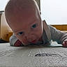 Aaron participe au concours pour gagner de l'argent avec cette photo : baby, infant, child, face, tummy, floor, texture, indoor, furniture, curious, closeup, person, clothing, hand, head, light, blur, background, expression, room