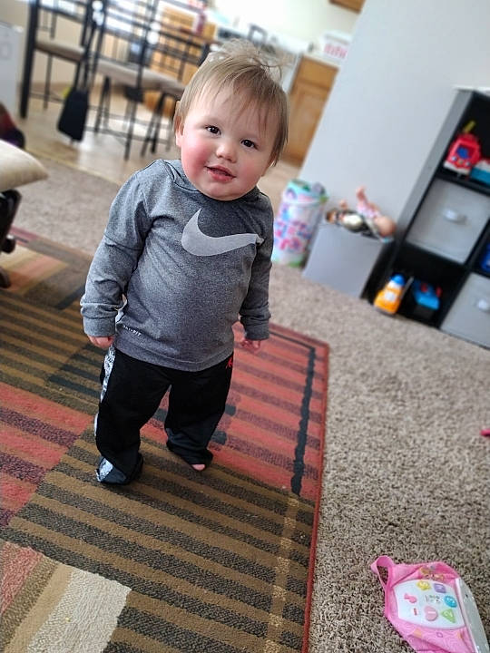 Lakota is registered to the contest to win money with this photo: baby, baby_toddler_clothing, carpet, child, floor, flooring, fun, happy, hardwood, leisure, pattern, person, play, room, sitting, skin, sleeve, smile, standing, toddler