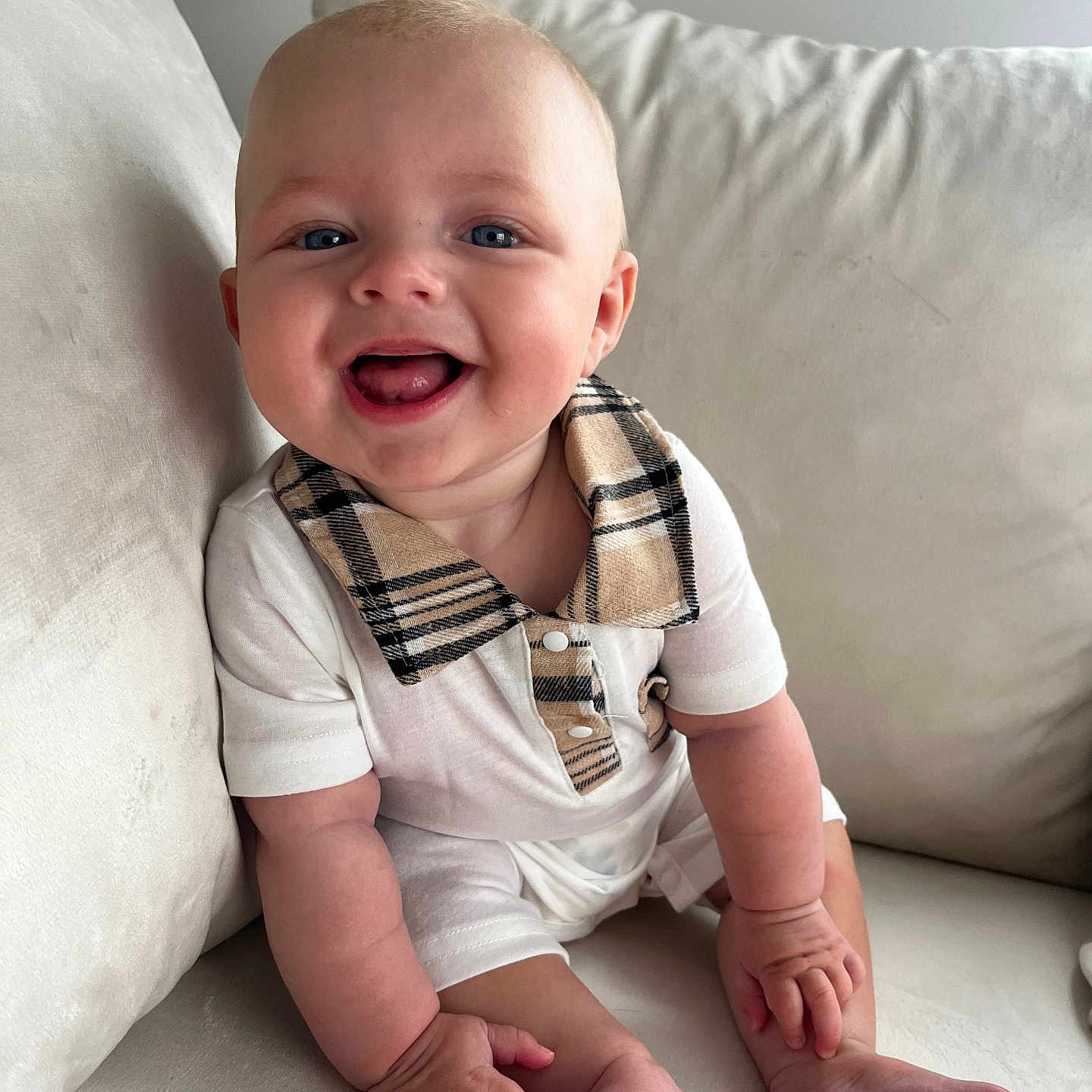 Elijah is registered to the contest to win money with this photo: baby, blue_eyes, child, comfort, couch, cozy, cute, feet, hands, happy, home, indoors, infant, plaid_collar, portrait, sitting, skin, smiling, white_clothing, young